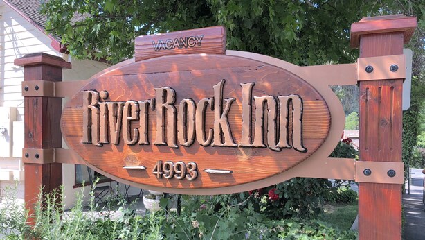 A wooden sign for River Rock Inn with the year 4993. - River Rock Inn (Mariposa)