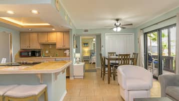 Deluxe Condo, 1 King Bed | Living area | 24-inch TV with cable channels