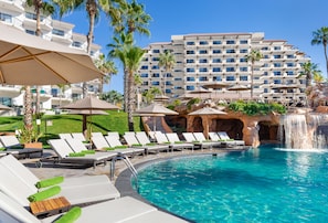 Relax by the pool surrounded by lounge chairs and a soothing waterfall feature.