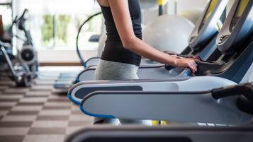 A gym with treadmills, exercise balls, and stationary bikes.