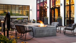An outdoor patio area with a fire feature, seating, and potted plants. - Element by Marriott Bozeman (Bozeman)