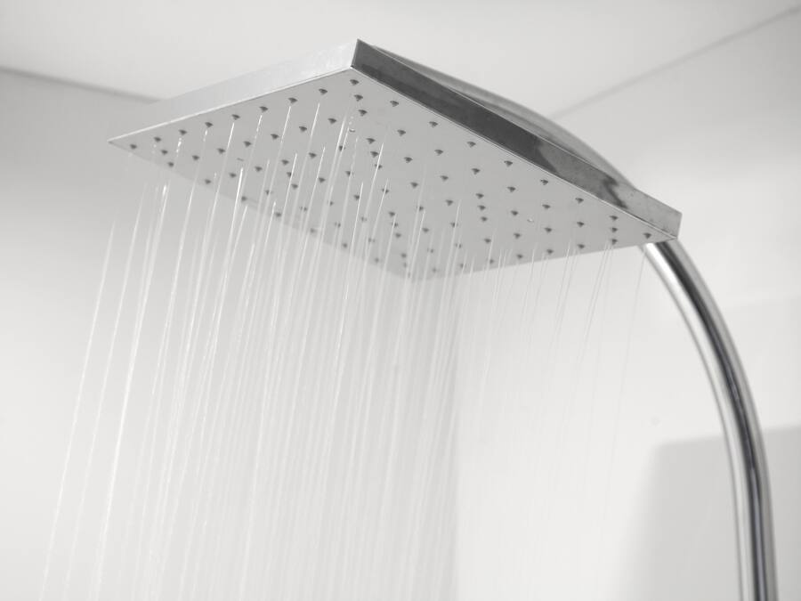 A modern showerhead with multiple nozzles, indicating a high-pressure shower system.