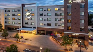 A hotel with a modern design, featuring a prominent logo, multiple floors, and a well-lit entrance area. - Element by Marriott Bozeman (Bozeman)