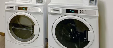 Two front-loading washing machines with digital displays, stacked on top of each other.
