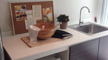 Full-sized fridge, microwave, stovetop, cookware/dishes/utensils