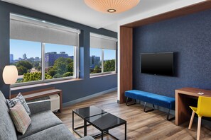 Ultra Savvy Suite, 1 King Bed, Living Area, Sofa bed, View | Down duvets, in-room safe, desk, laptop workspace