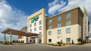 A Holiday Inn Express hotel with a modern design, featuring a covered entrance and a clear sky. - Holiday Inn Express & Suites Bay City by IHG (Bay City)