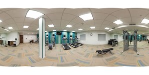 A panoramic view of a gym with treadmills, elliptical machines, and weightlifting equipment. - Holiday Inn Express & Suites Pahrump by IHG (Pahrump)