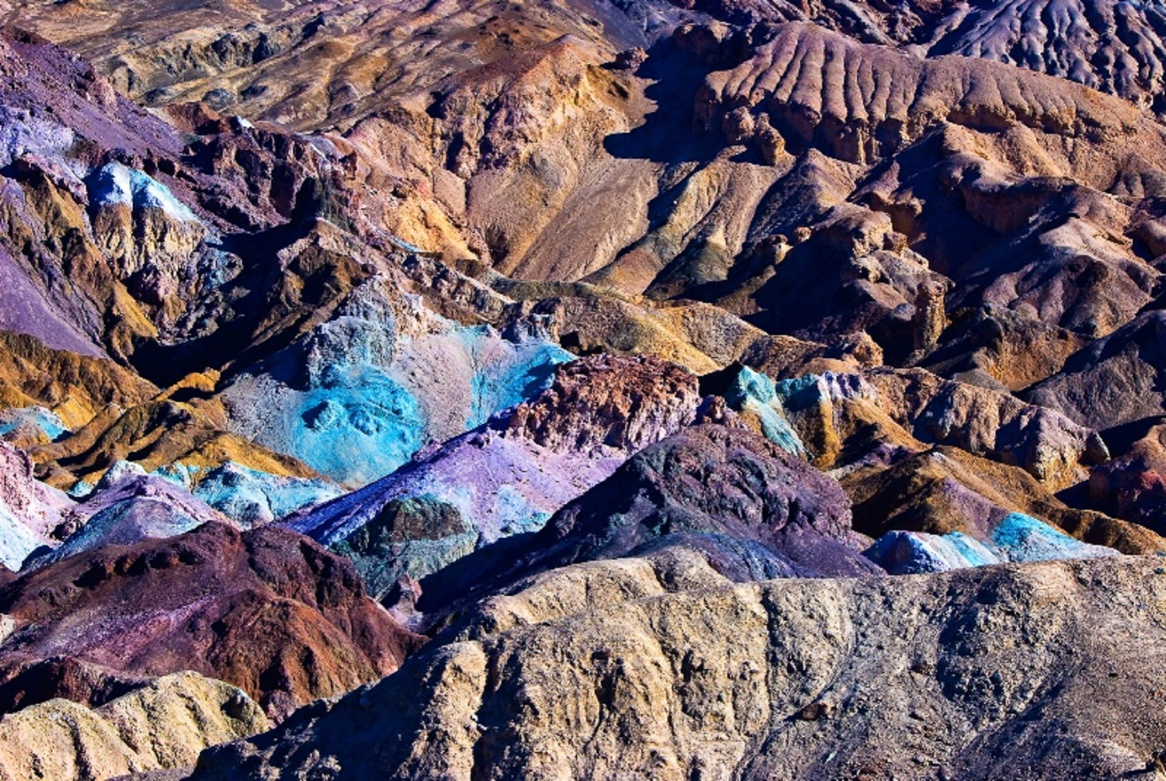 A rugged landscape with various rock formations and a river.