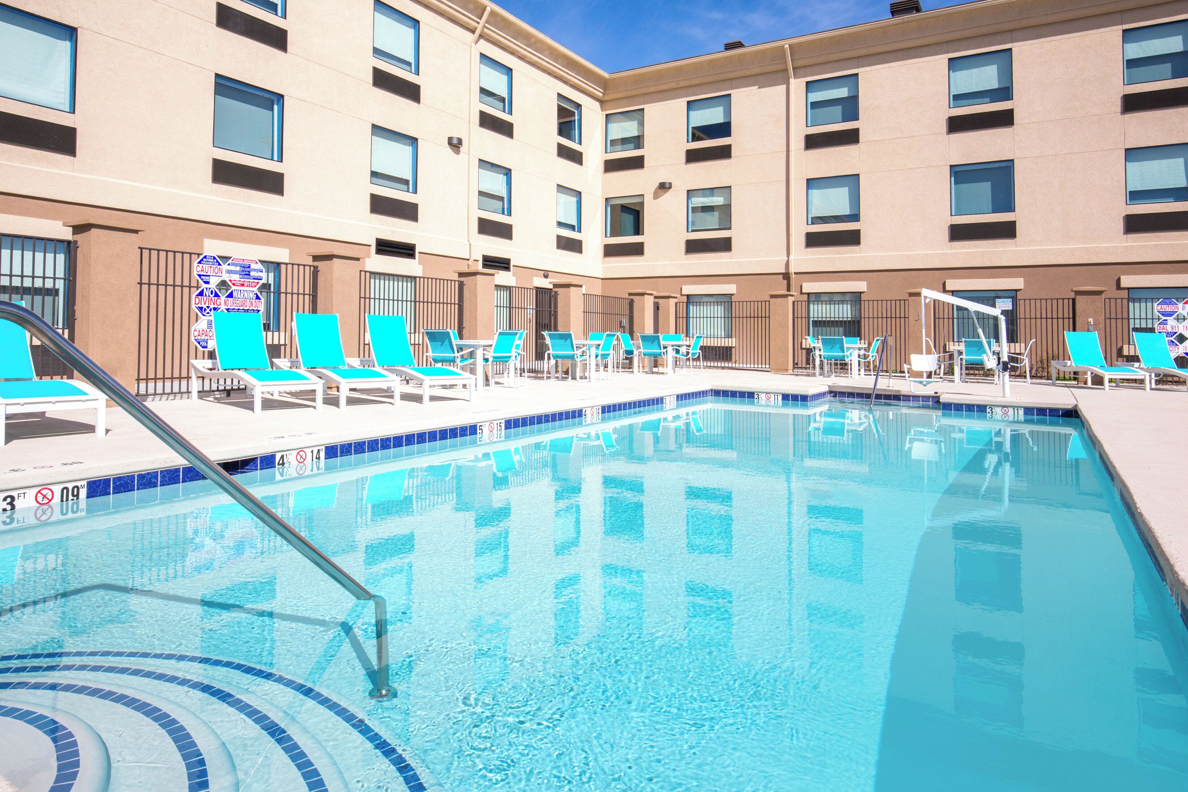 Outdoor pool, open 8 AM to 10 PM, pool loungers