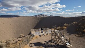 A desert landscape with a viewing platform and a person standing on it. - Holiday Inn Express & Suites Pahrump by IHG (Pahrump)