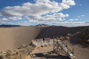 A desert landscape with a viewing platform and a person standing on it. - Holiday Inn Express & Suites Pahrump by IHG (Pahrump)