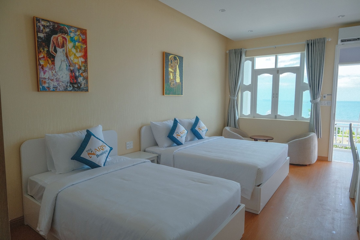 Deluxe Triple Room, Sea View | Minibar, in-room safe, desk, blackout curtains