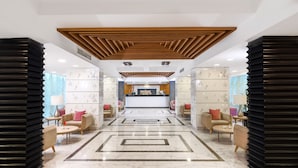 A spacious lobby with a reception desk, seating area, and a modern ceiling design. - Tolip El Galaa Cairo Hotel (Cairo)