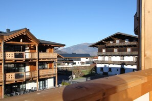 A wooden building with balconies and a mountain view.