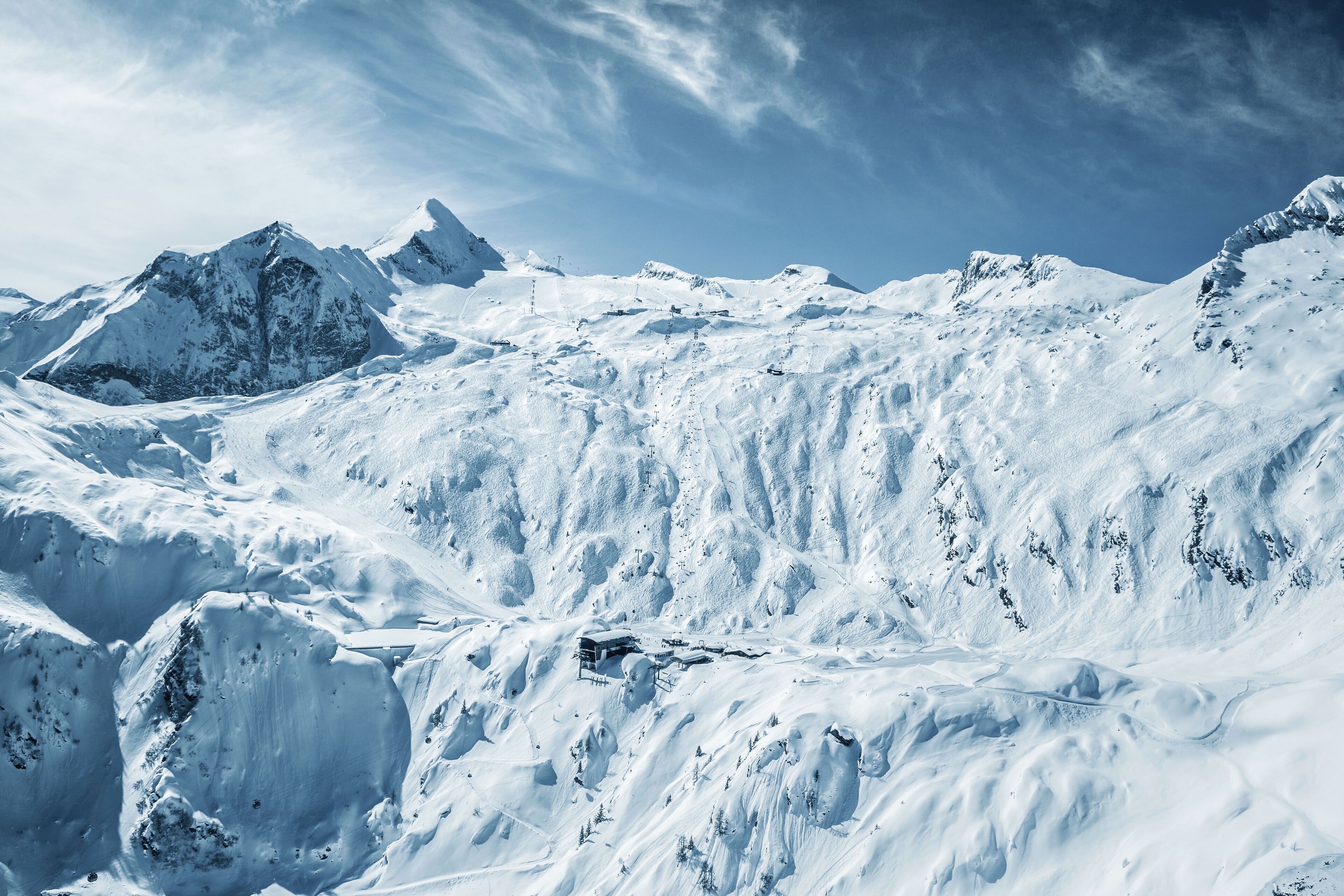 A snow-covered mountain landscape with a ski resort.
