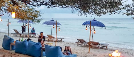 On the beach, white sand, sun loungers, beach umbrellas