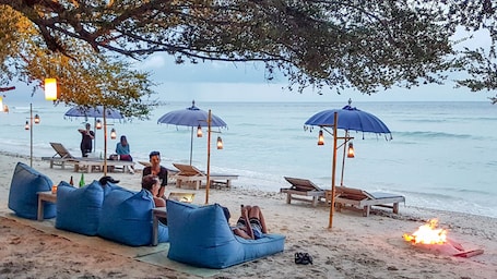 On the beach, white sand, sun loungers, beach umbrellas