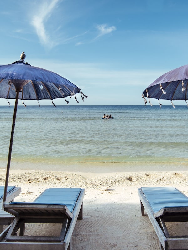 On the beach, white sand, sun loungers, beach umbrellas