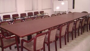 A conference room with a long table and multiple chairs. - Innra (Kolkata)