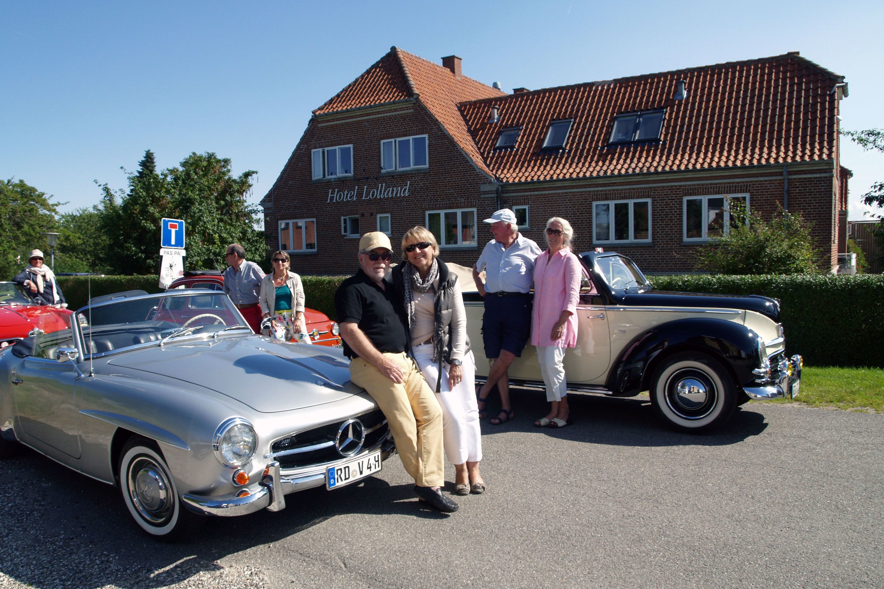 A vintage car parked in front of a building labeled "Hotel Lolland."