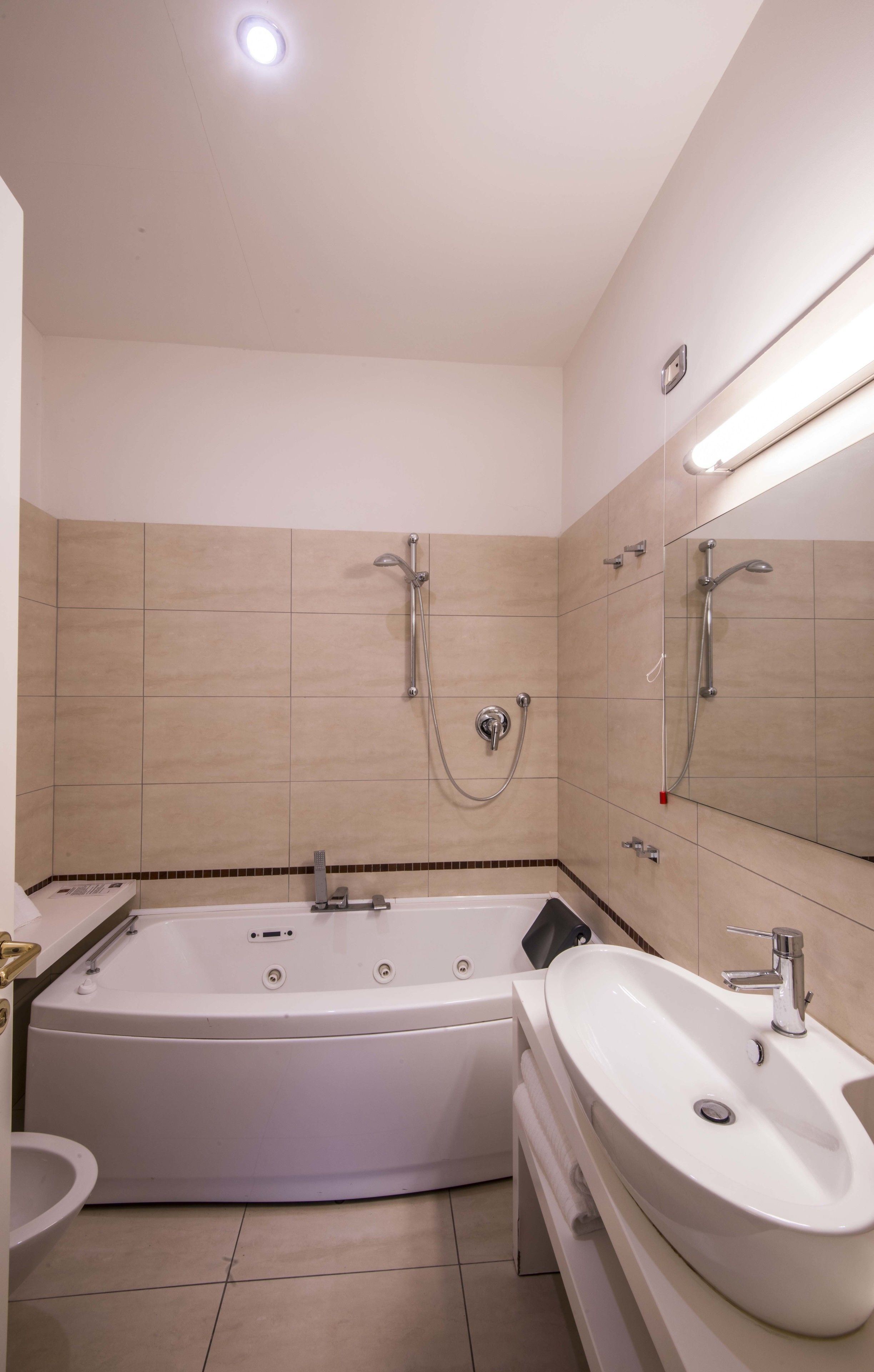 A modern bathroom with a bathtub, a sink, and a shower.