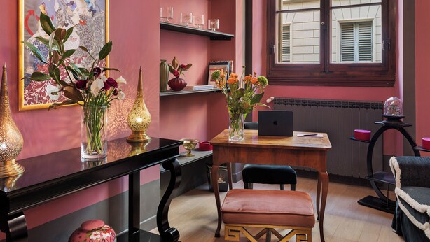 A room with a wooden table, a laptop, a bench, and a window with shutters. - Palazzo Branchi (Florence)