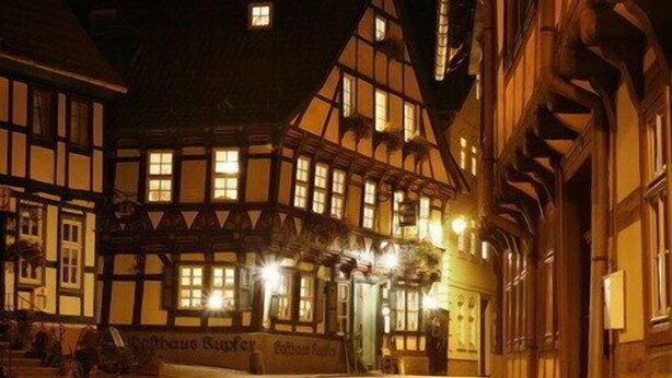 A traditional half-timbered building with multiple windows and a sign that reads "Hotel Sailer." - Gasthaus Kupfer (Südharz)