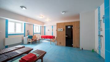 Cozy retreat with a wooden door leading to another room, featuring a comfortable bed and a small table.