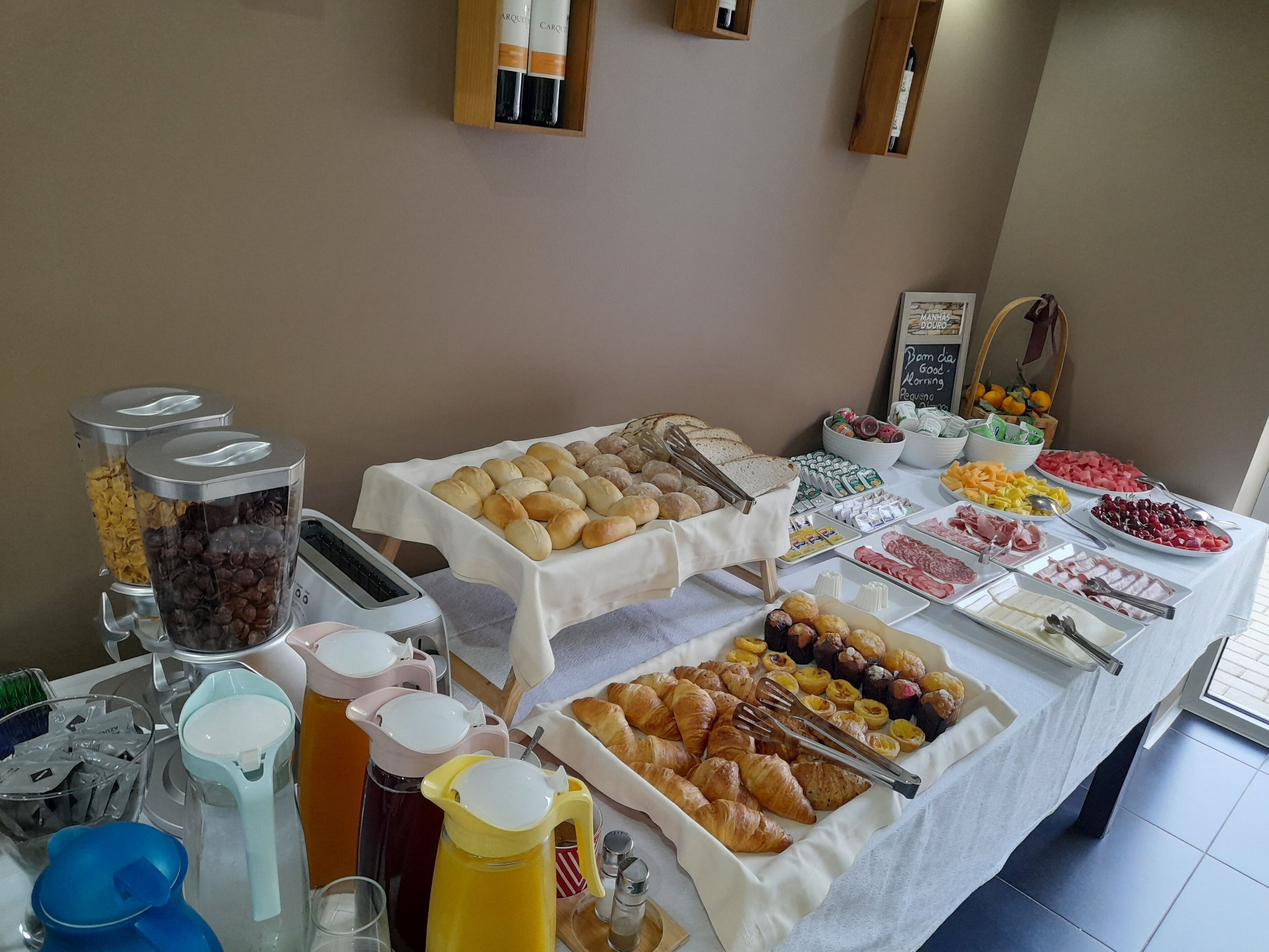 A buffet table with various food items and beverages.