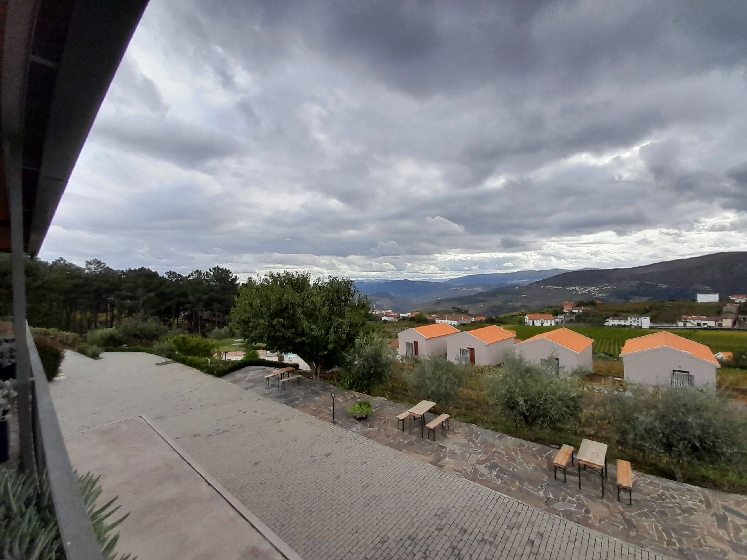 A view of a residential area with houses and a paved walkway.