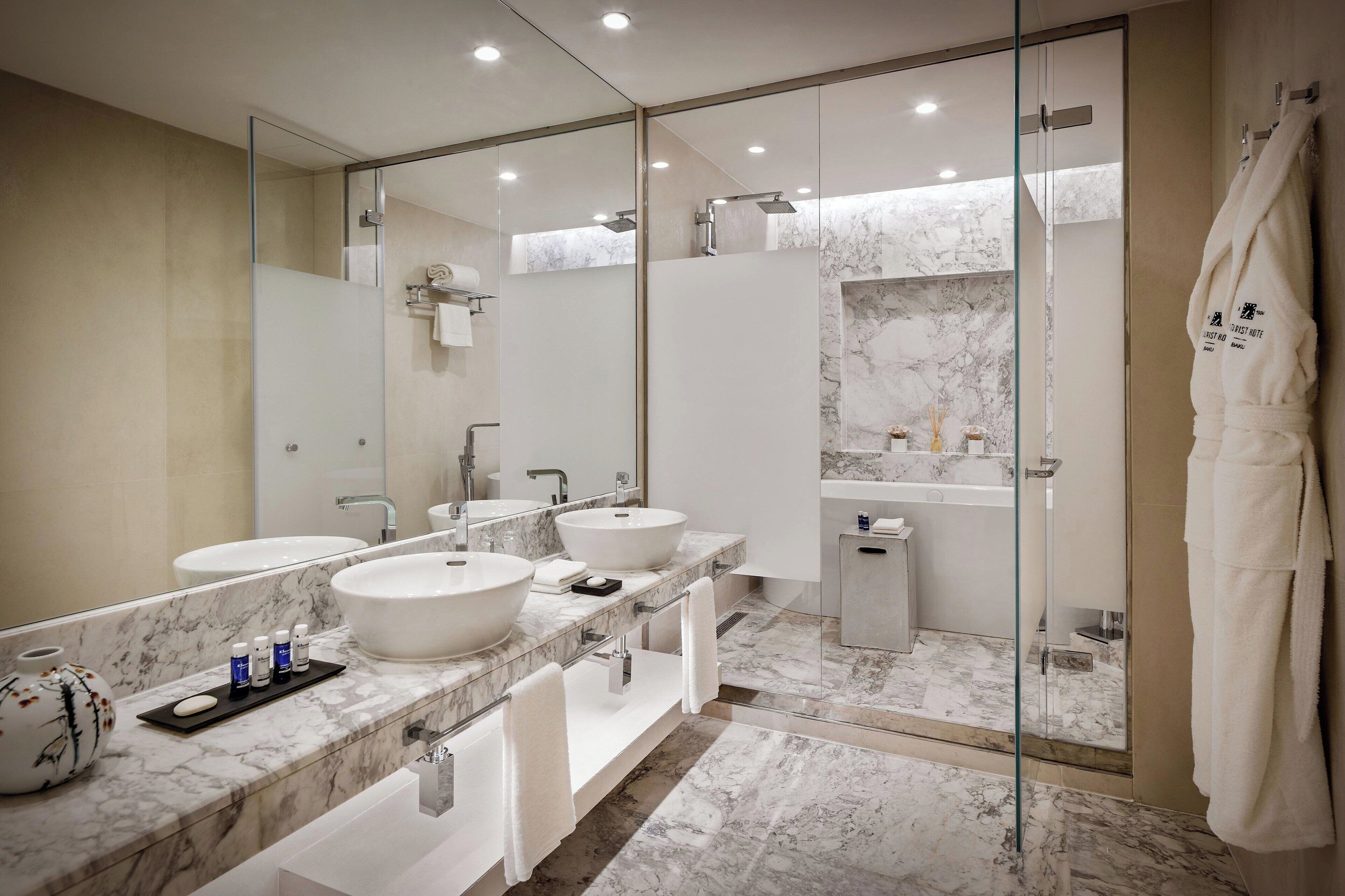 designer toiletries, hair dryer, bathrobes, slippers