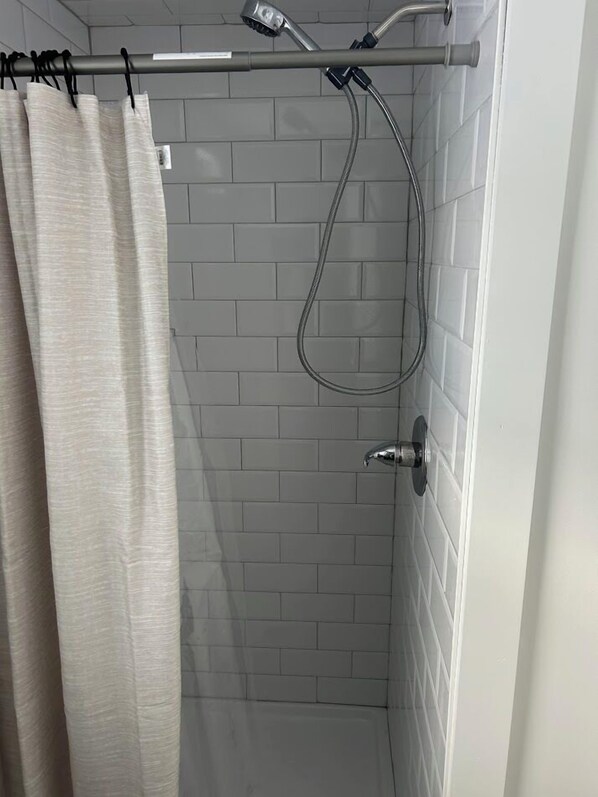 Habitación básica, 1 cama Queen size | Baño | Regadera, amenidades de baño gratuitas, secadora de cabello