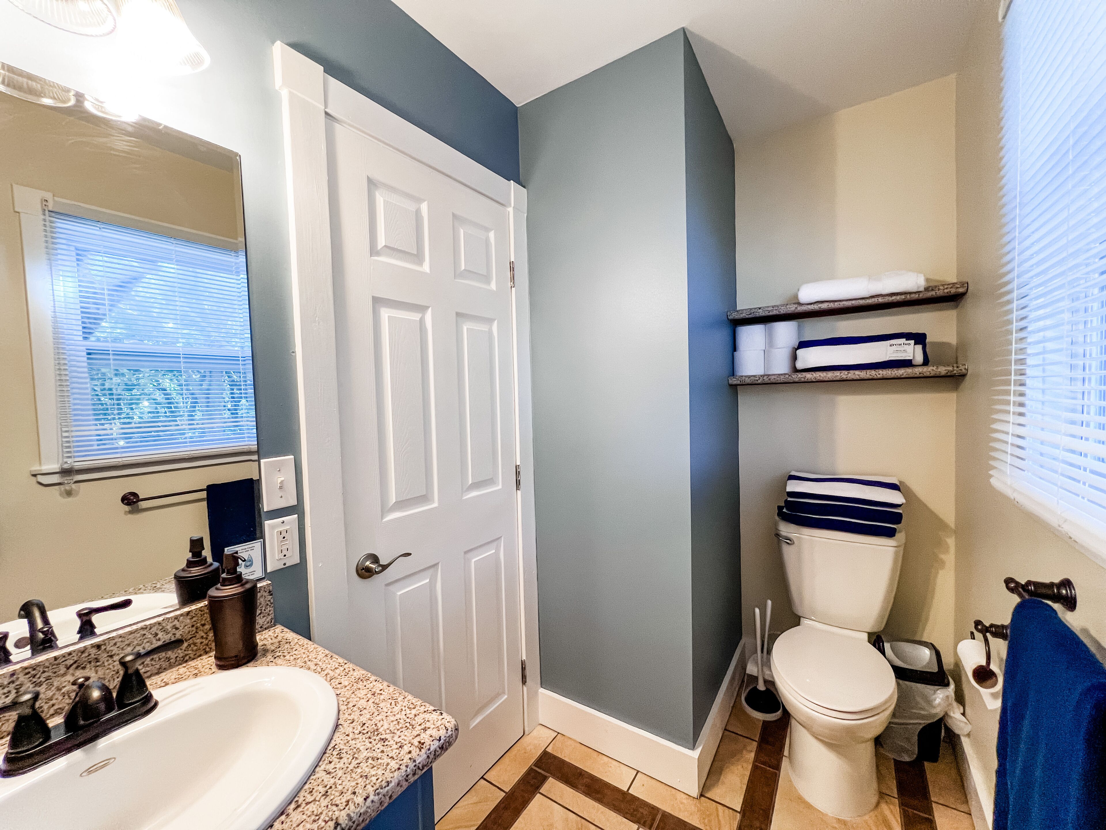 A bathroom with a white sink, a toilet, and a shower area.