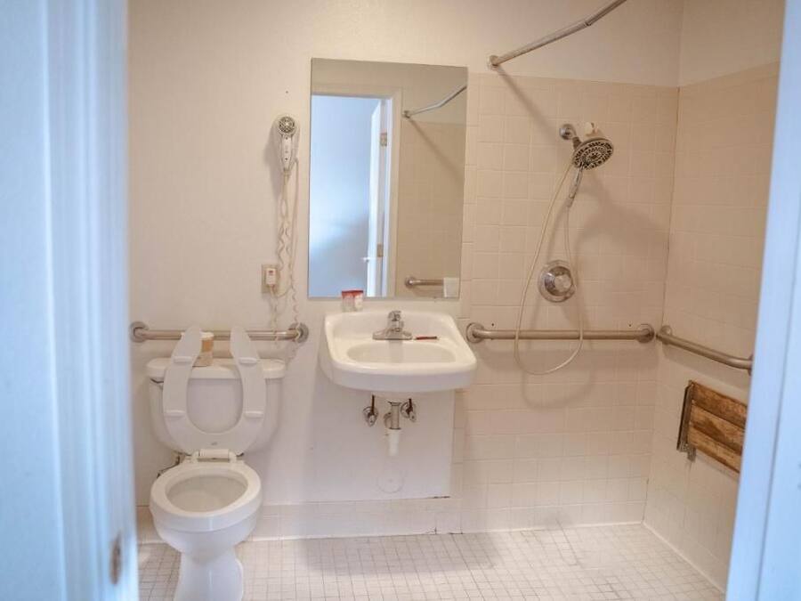 A bathroom with a toilet, sink, and shower.