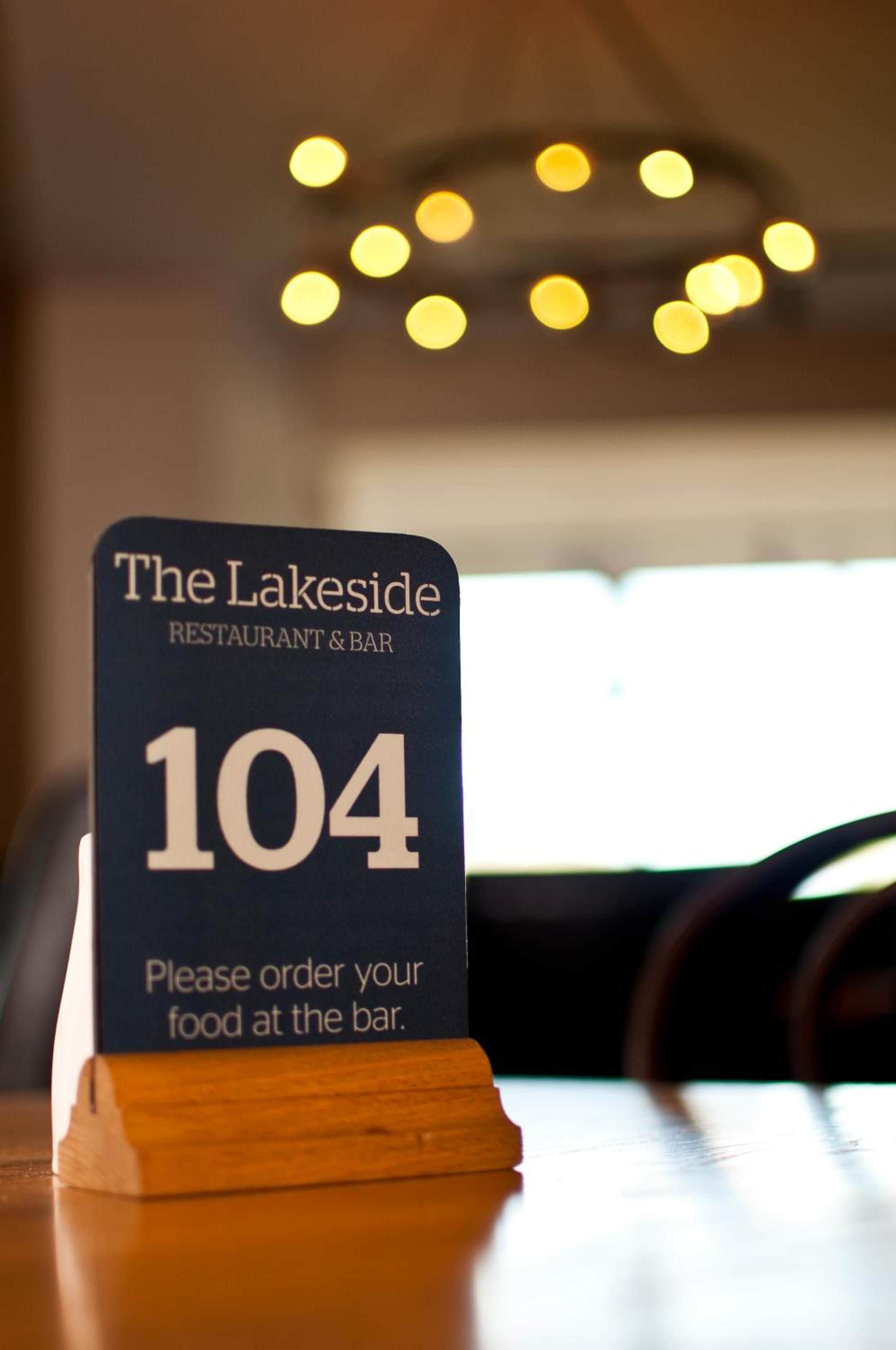 A sign for The Lakeside Restaurant & Bar, number 104, with a prompt to order food at the bar.