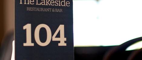 A sign for The Lakeside Restaurant & Bar, number 104, with a prompt to order food at the bar.