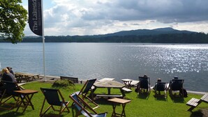 A lakeside restaurant with outdoor seating and a flag indicating its name. - YHA Ambleside - Hostel (Ambleside)
