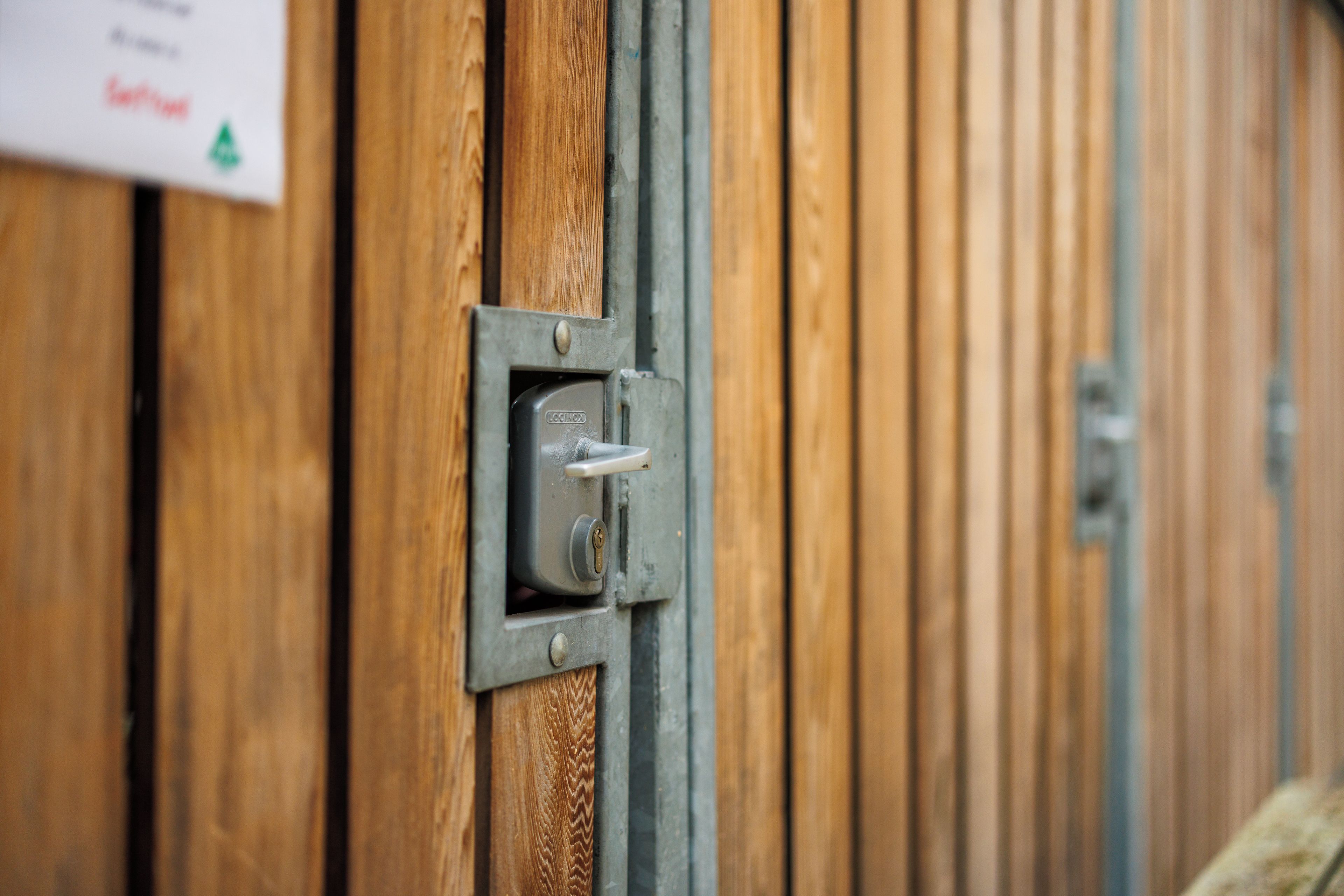 A close-up of a door with a metal lock and a keyhole.