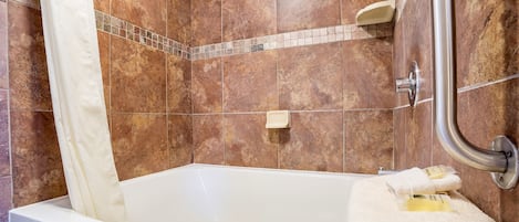 A bathroom with a bathtub, a shower, and a toilet.