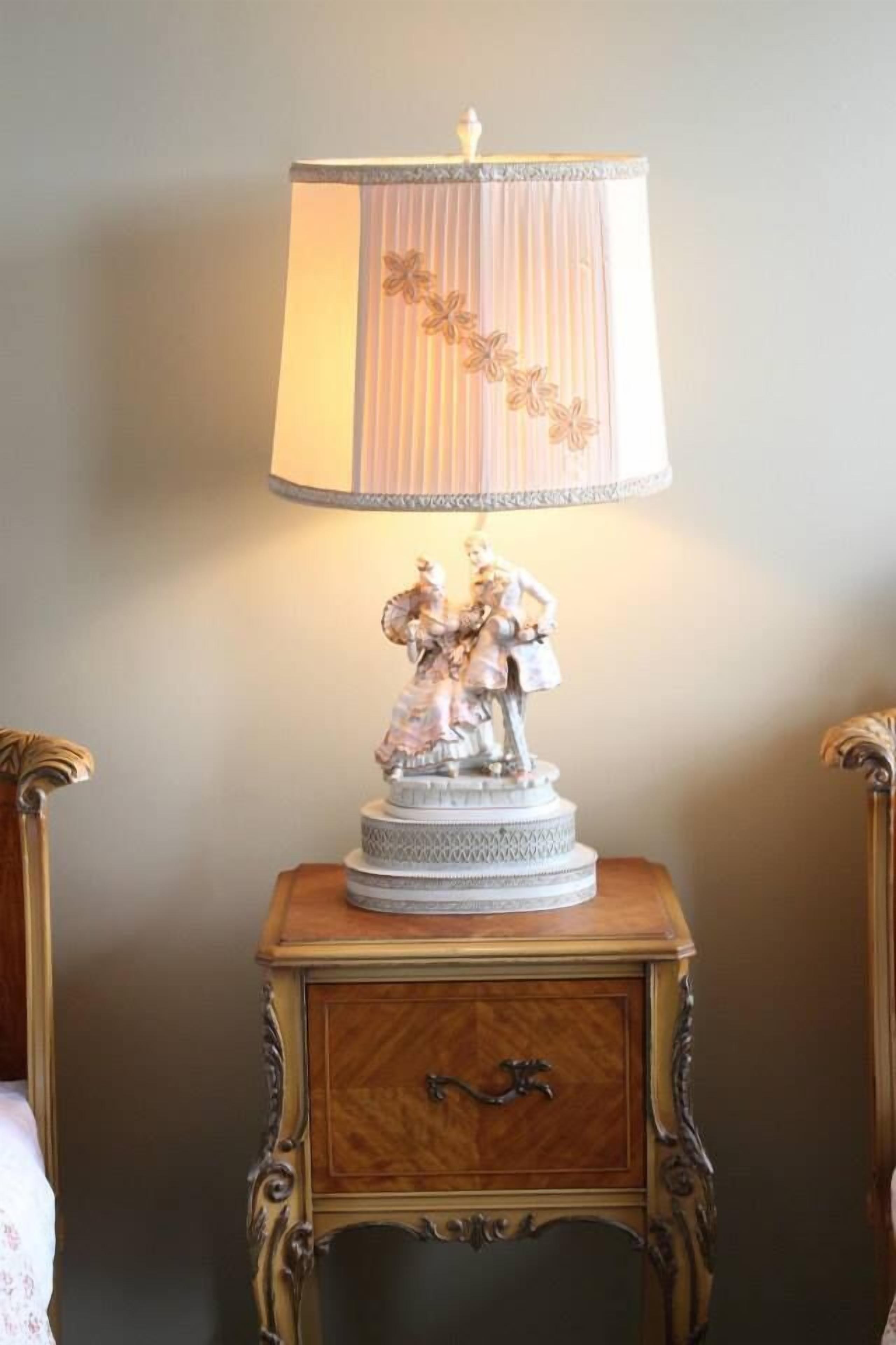 A table lamp with a decorative base and a striped lampshade.