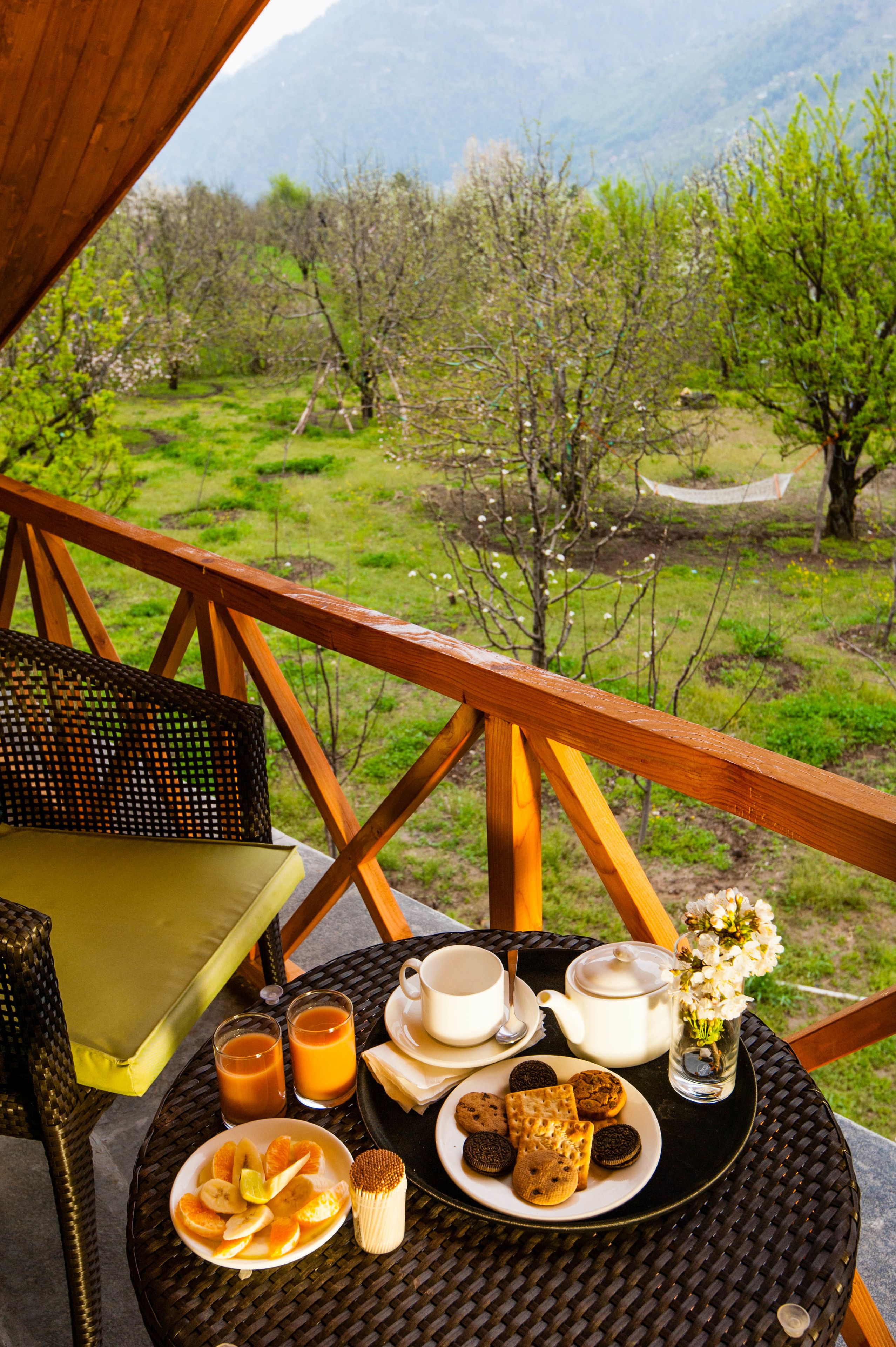 Desayuno con una mesa, platos de comida y vistas a un paisaje montañoso.