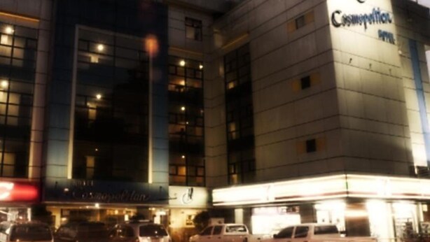 A hotel with a modern facade, multiple floors, and a prominent sign for 'Cosmetology'. - Hotel Cosmopolitan (Baguio)
