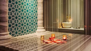 Bathroom features a large mirror, sink, and decorative tile wall with a geometric pattern.