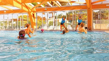 Relax by the pool surrounded by comfortable seating and large windows.