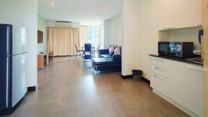 A modern apartment with a kitchen, dining area, and living room. - 14 Living (Bangkok)