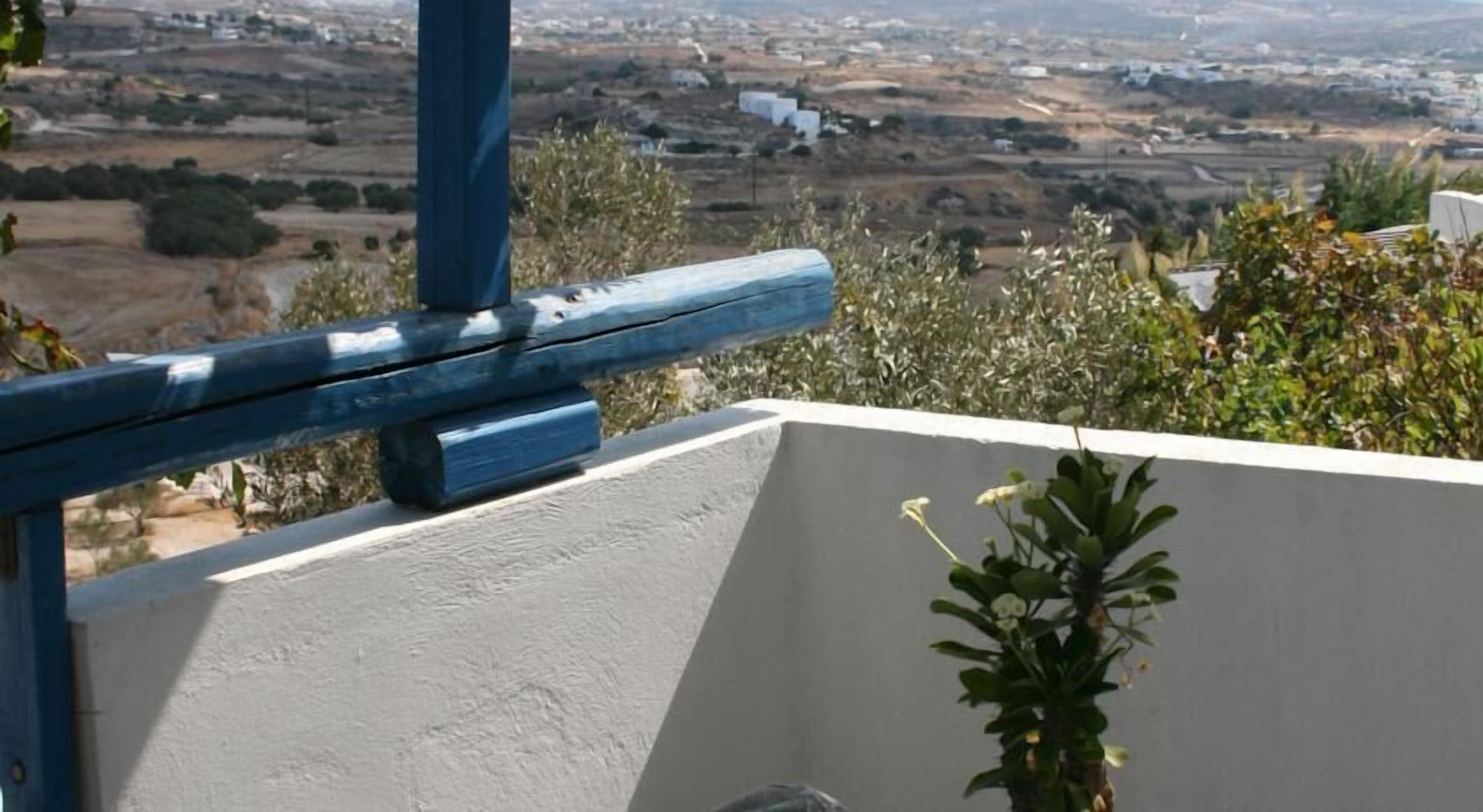 A balcony with a view of a rural landscape.