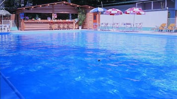 Outdoor pool, open 10 AM to 5 PM, pool umbrellas