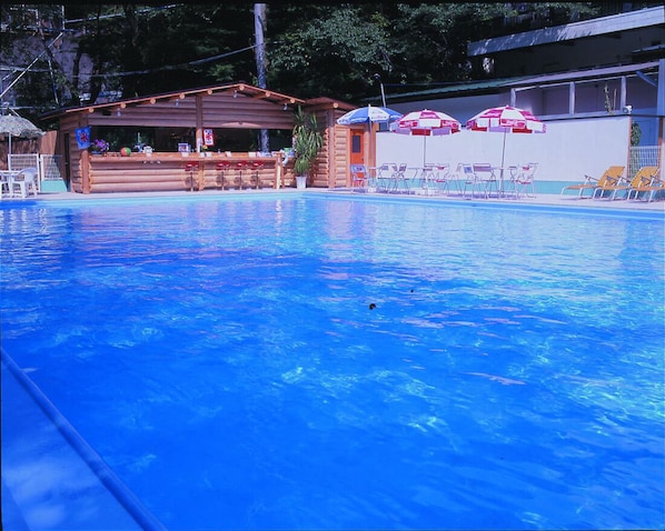 Outdoor pool, open 10 AM to 5 PM, pool umbrellas