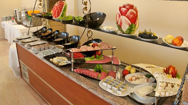 A buffet with various food items and condiments. - Abel Hotel (Istanbul)